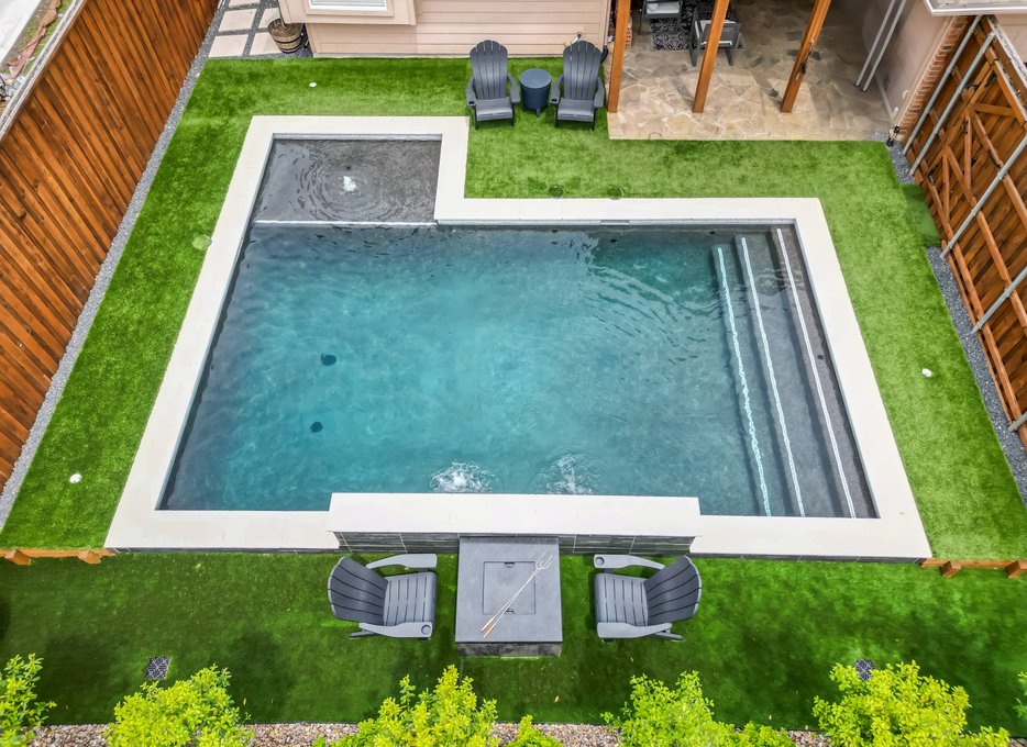 Aerial view of modern backyard pool with spa