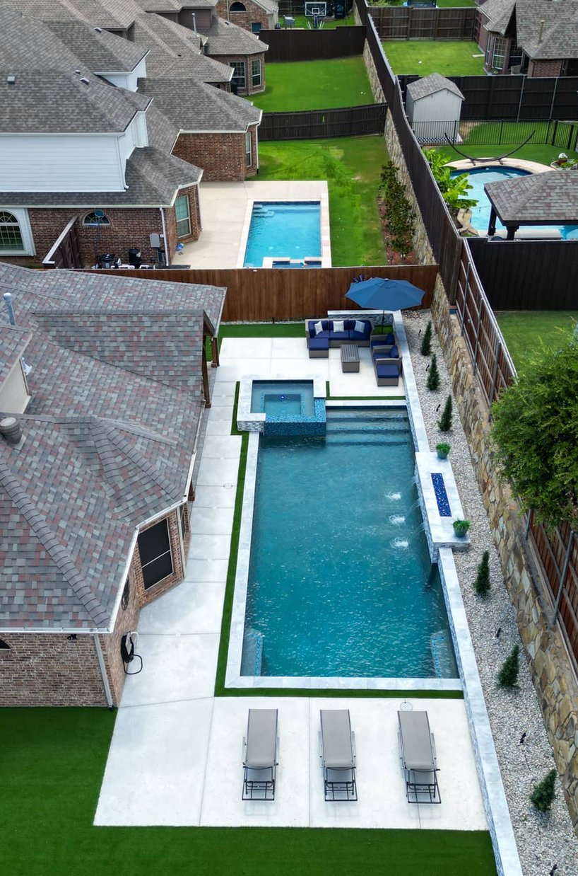Aerial narrow lap pool with spa and seating