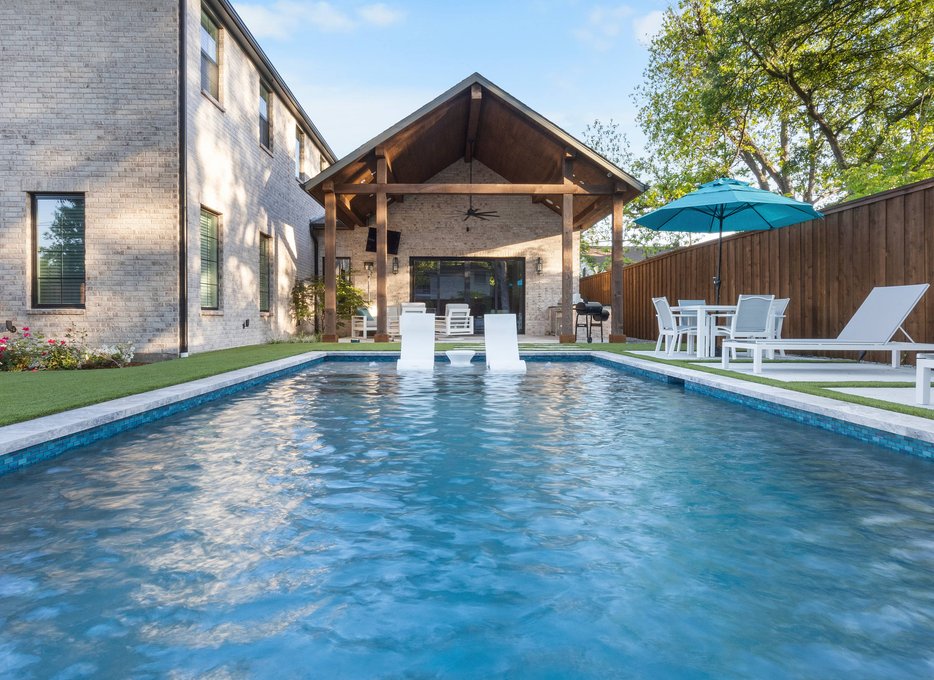 Rectangular pool with in-water loungers and pavilion