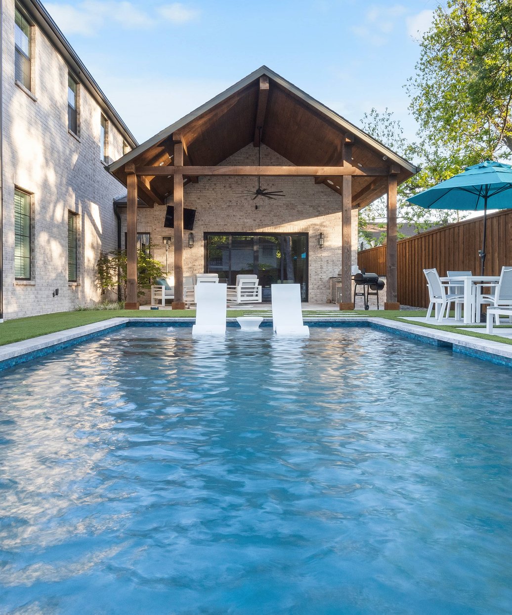 Custom gunite pool with spa and water features built by TidalWave Custom Pools