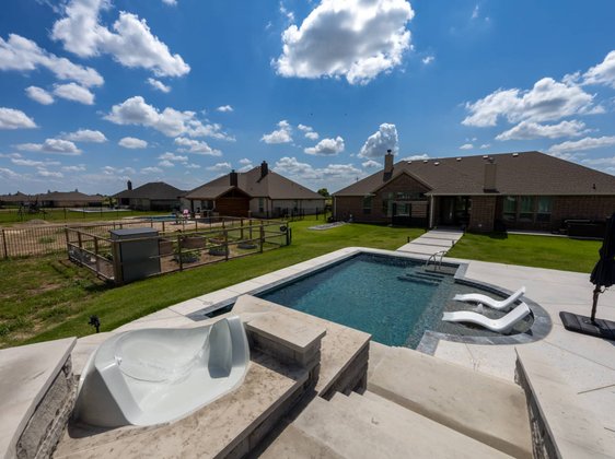 Pool with water slide and in-water loungers