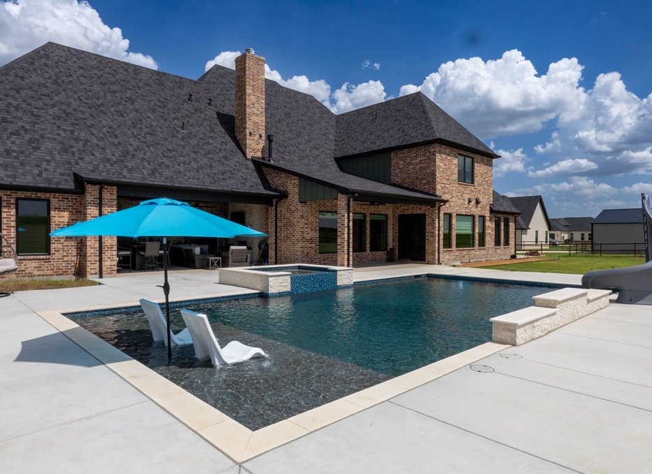 Large pool with water slide and tanning shelf