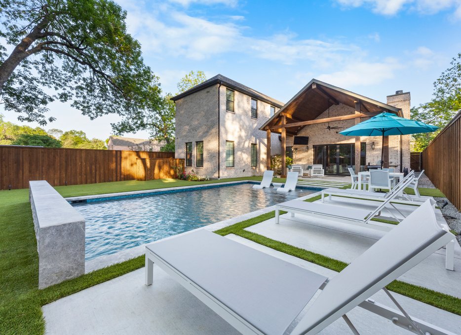Rectangular pool with white loungers and pavilion