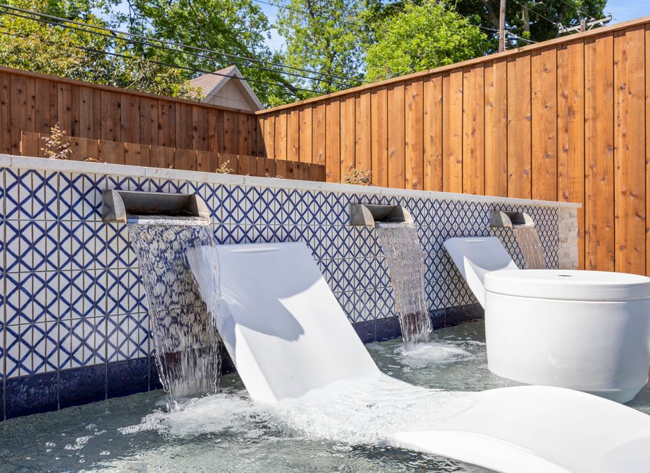 Tiled water wall with scupper features and loungers